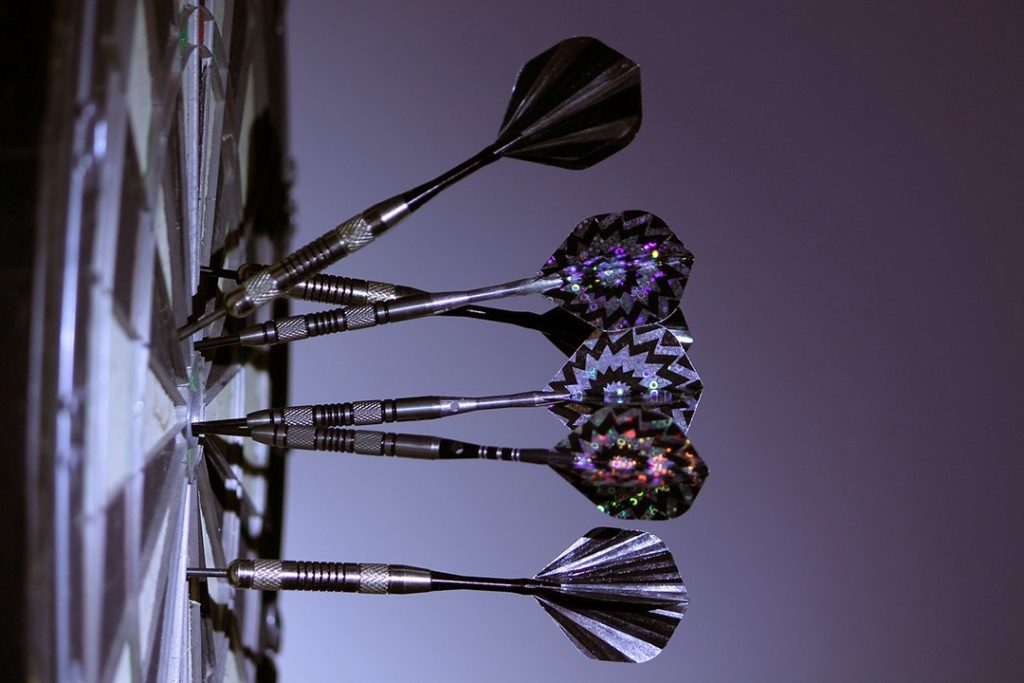 How to combine content with Facebook ads Darts stuck in a dart board Facebook