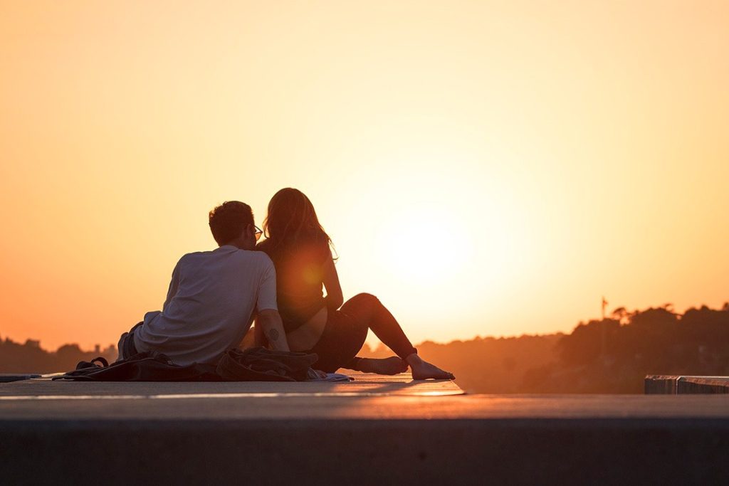 Dating terminology and behaviours Couple dating behaviours watching sunset on rooftop