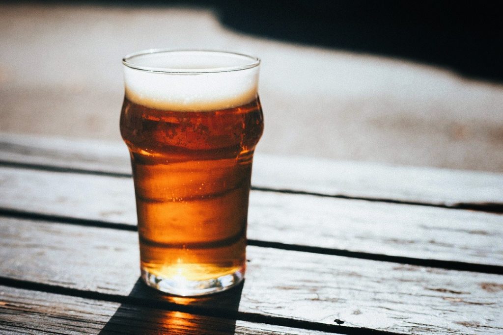 How to brew your own beer at home Glass of beer on wooden table